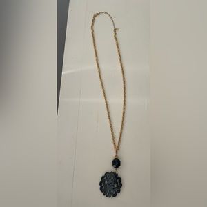 Gold long necklace with a black medallion and bead